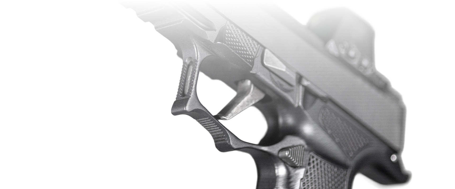 Close-up of a handgun trigger and grip texture detail